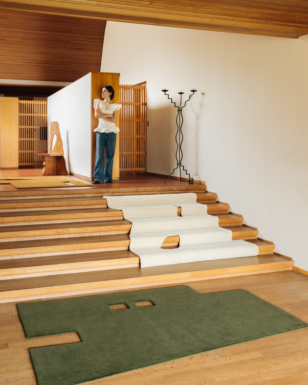 The geometrically shaped plush rugs Garance in Dusty White, Moss and Leo displayed in mid-century home together with the artist.