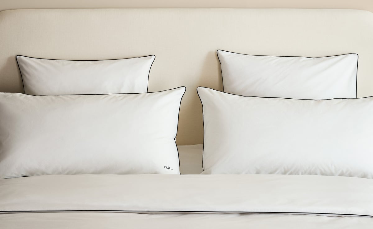 Percale Duvet Cover Set in Crisp White/Black styled on a bed, with white cotton percale finished with fine black piping for a sharp, tailored contrast.