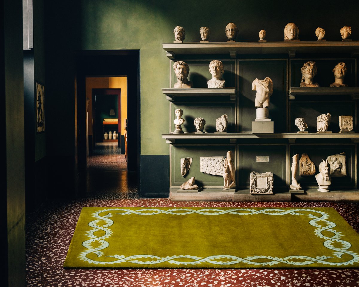 Campbell Rey 2023 collection plush wool rug Climbing Vine - Olive photographed in a colorful room with beautiful art at Thorvaldsen Museum in Denmark.