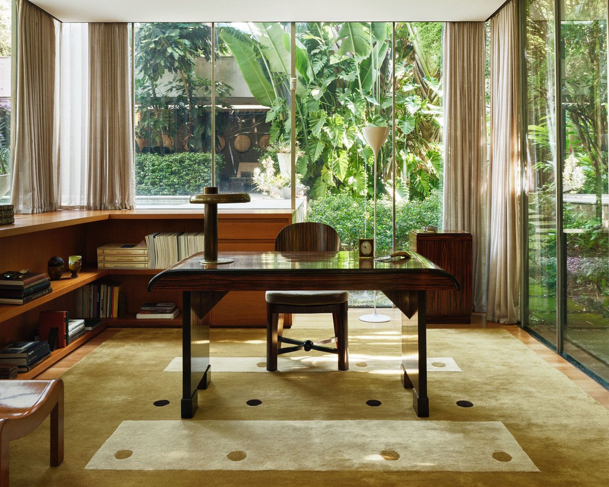Dots rug in Olive by Studio Mellone, photographed in São Paulo, Brazil, shown in a modern interior with warm wood, large windows, and soft daylight.