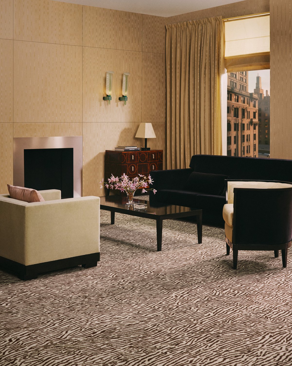 A wall-to-wall carpet with a brown and cream tiger stripe, in a room with a steel fireplace and a golden curtain.