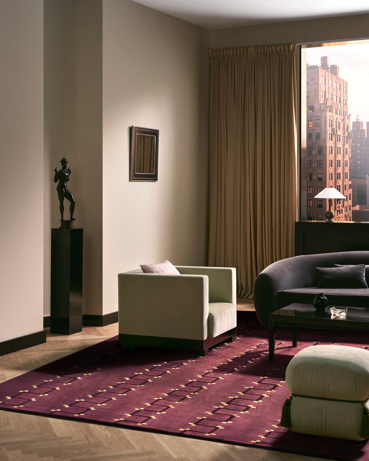 Matches in Plum, ein Hochflor-Teppich aus Wolle mit dunklen Linienmustern und goldenen Punkten, unter einem cremefarbenen Sessel und einem dunklen Sofa.