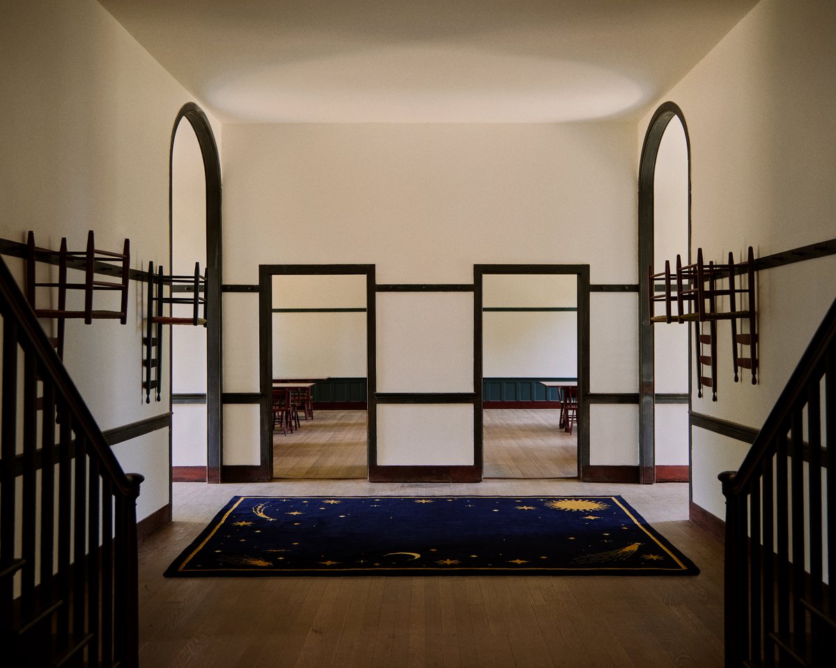 Plush wool rug Celestial in collaboration with ASH pictured in a spacious entrance hall with wooden beam detailing.