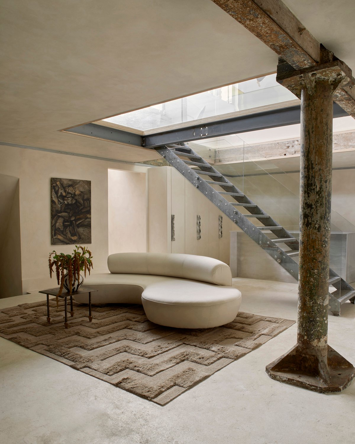 Hochfloriger Wollteppich Boho Brown Mix, abgebildet in einem Lounge-Raum im modernen Brutalismus-Stil mit architektonischen Metalldetails und einem weichen weißen Sofa in London.