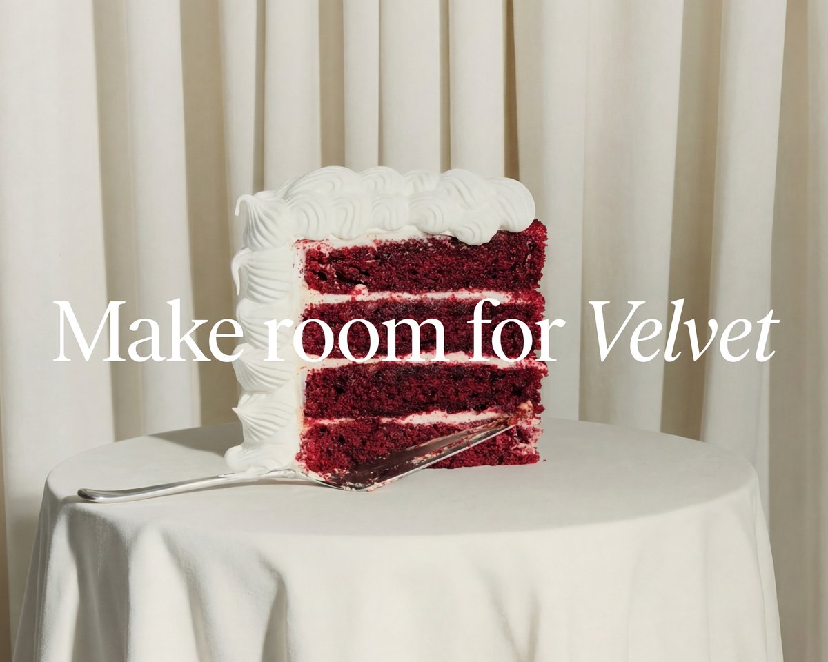 Slice of red velvet cake on a table in front of light curtains, with the text “Make room for Velvet” overlaid.