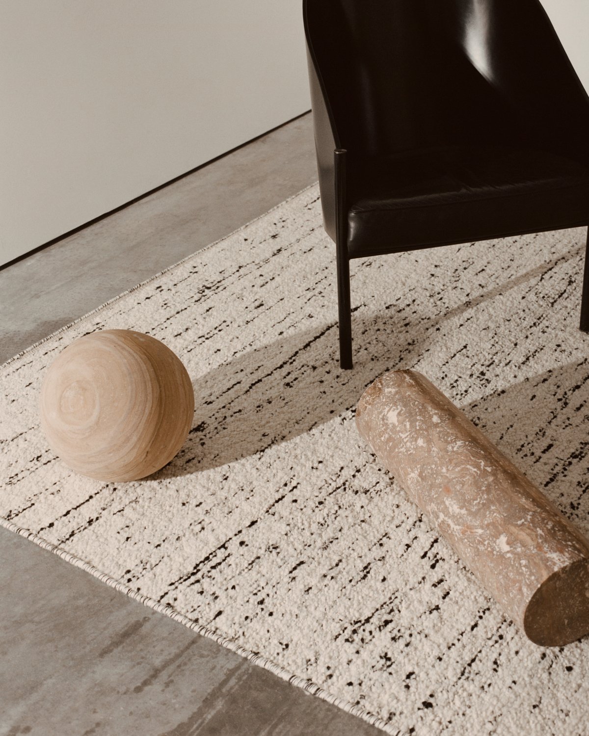 Bouclé Black and White in close up with objects on the floor.
