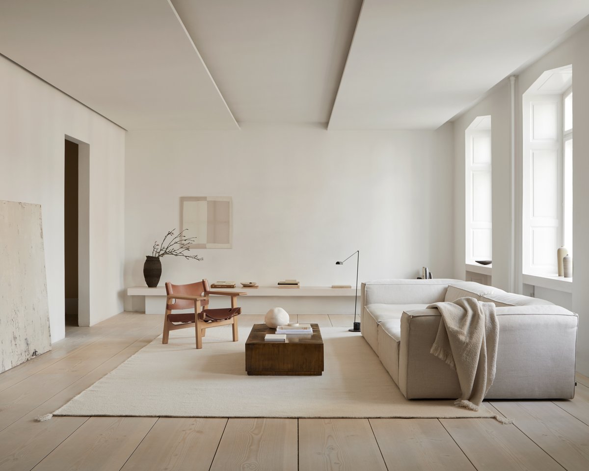 Merino Natural white rug pictured in a modern white living room.