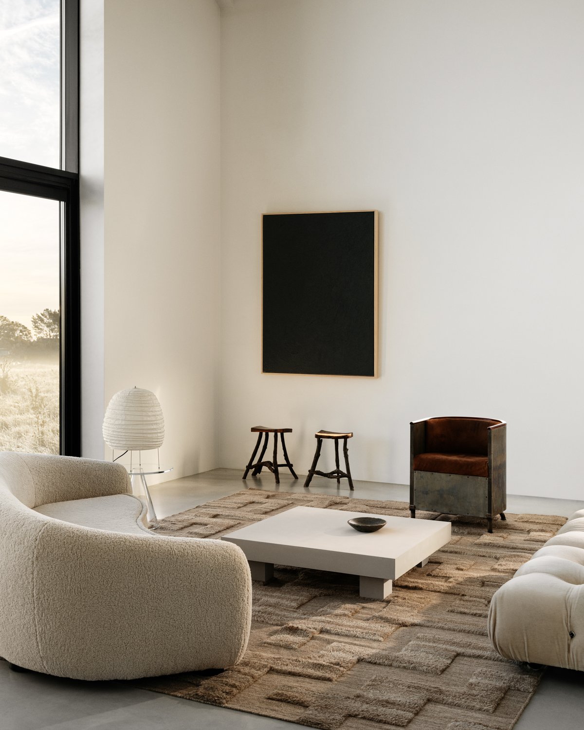 Shag wool rug Boho in Brown Mix pictured in a minimalistic living room with large windows and artistic interior design details in Sweden.