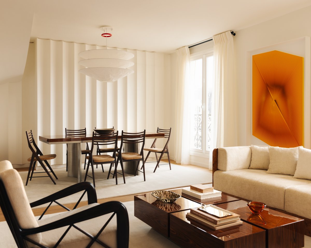 Elegant open-plan dining and living room with mid-century furniture, soft neutral tones, and the Grand – Dusty White rug enhancing the light interior.