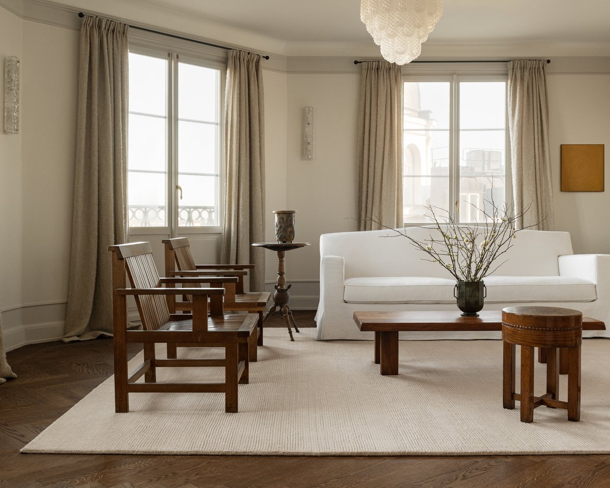 Park rug in the shade Almond mirrored in a bright living room, with wooden furniture and a white sofa in Stockholm, Sweden.