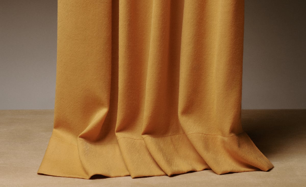 The Blackout curtains in Leo are shown in a close-up view, highlighting their heavy drape and rich golden tone against a neutral background.