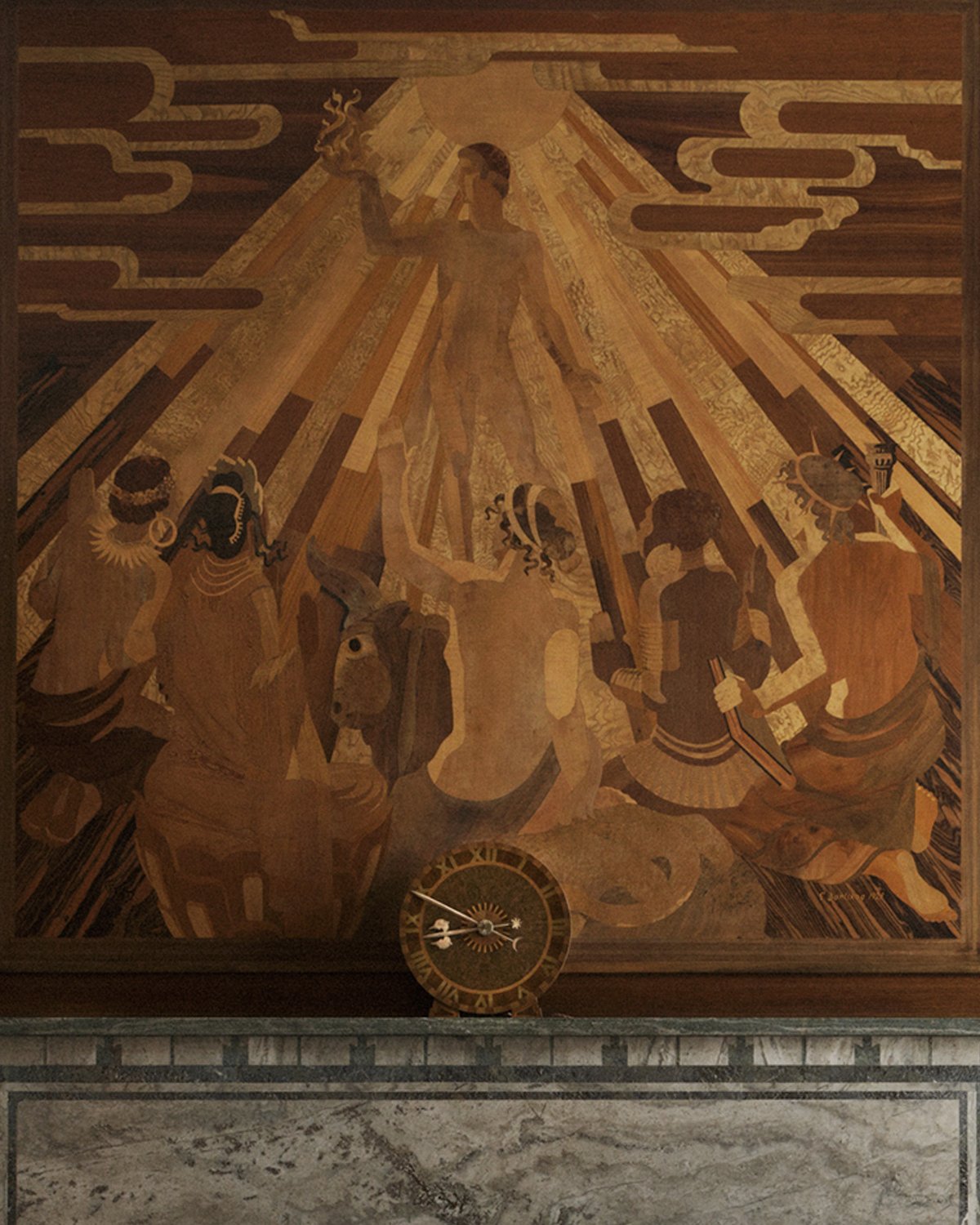 Picture of a wooden mural above a stone fireplace.