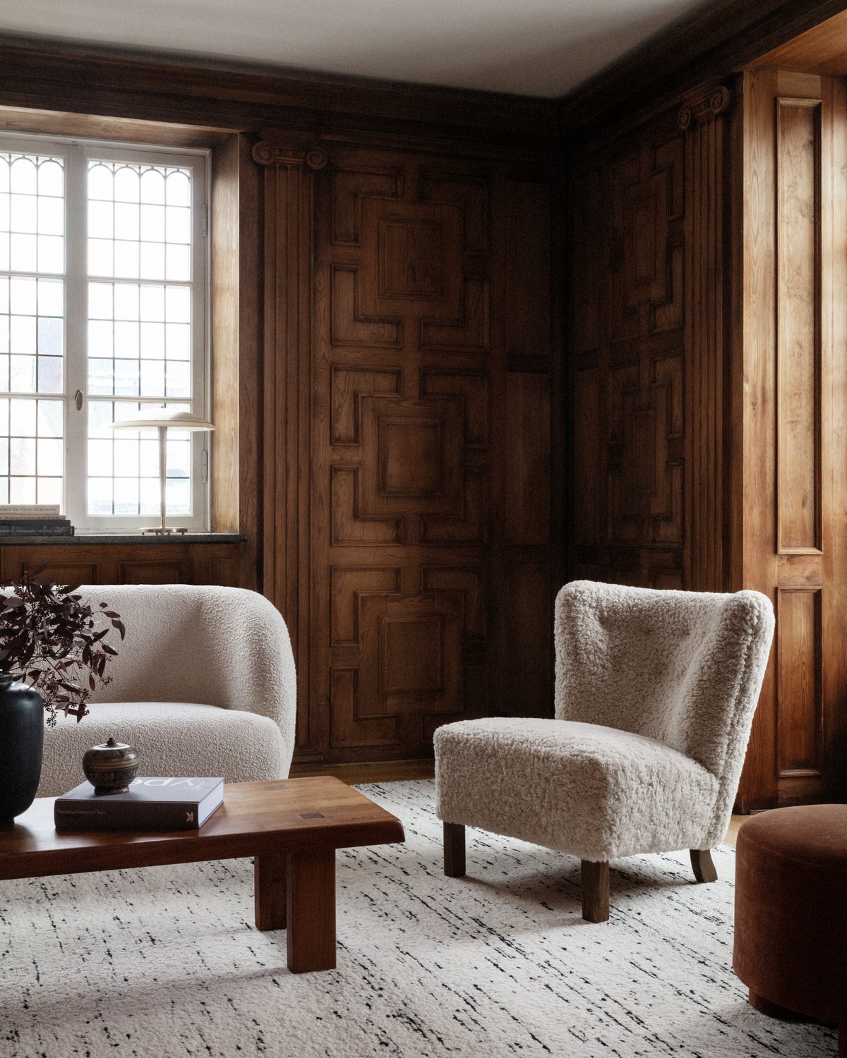 Bouclé in Black and White styled in a Scandinavian home with dark wooden details.
