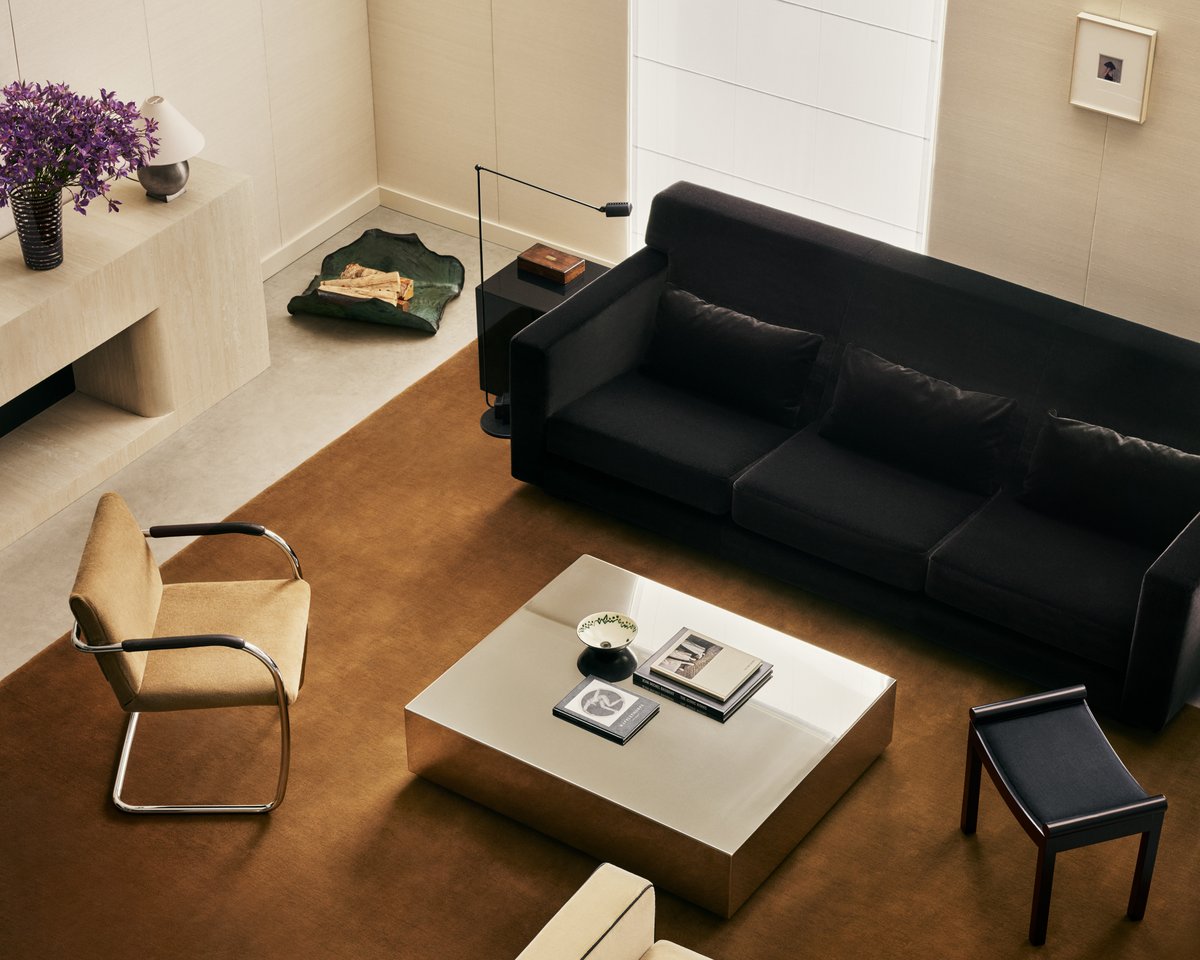 Grand in Pecan, photographed from above in a bright living room beneath a black sofa and low coffee table.