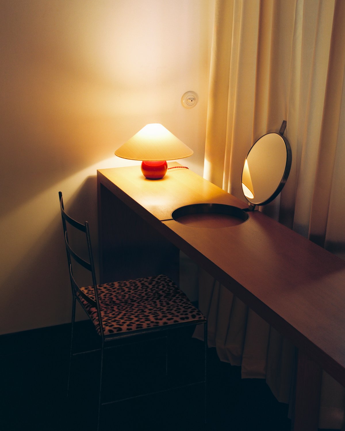 The Sheer in Sunrise, photographed in soft morning light beside a wooden vanity, where the sheer warm-white curtains create an airy, sunlit feel.