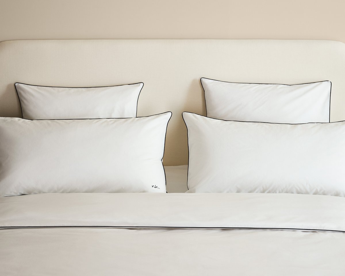 Bed styled with the Signature Headboard in Warm White, dressed in the Percale Bedding Collection in Crisp White/Black.