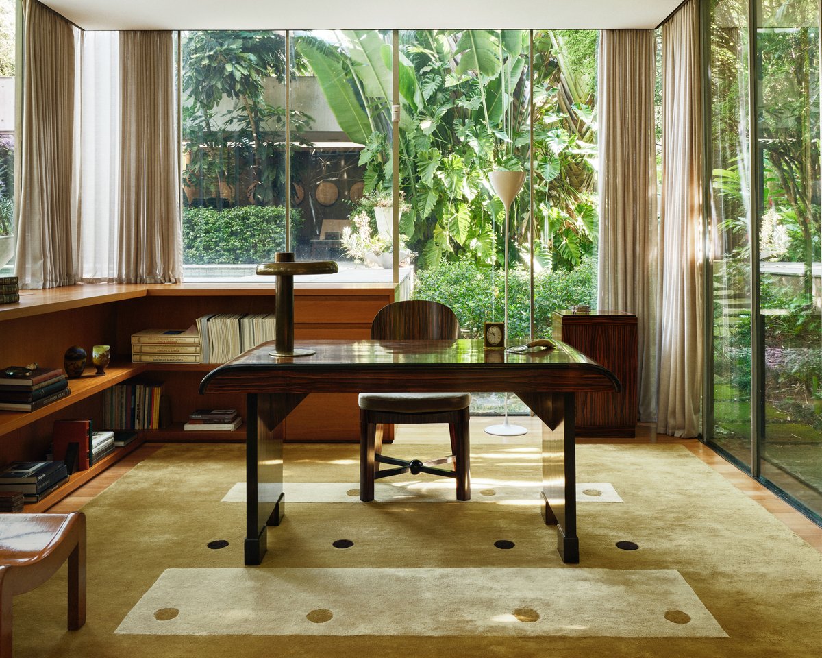 Dots rug in Olive by Studio Mellone, photographed in São Paulo, Brazil, shown in a modern interior with warm wood, large windows, and soft daylight.