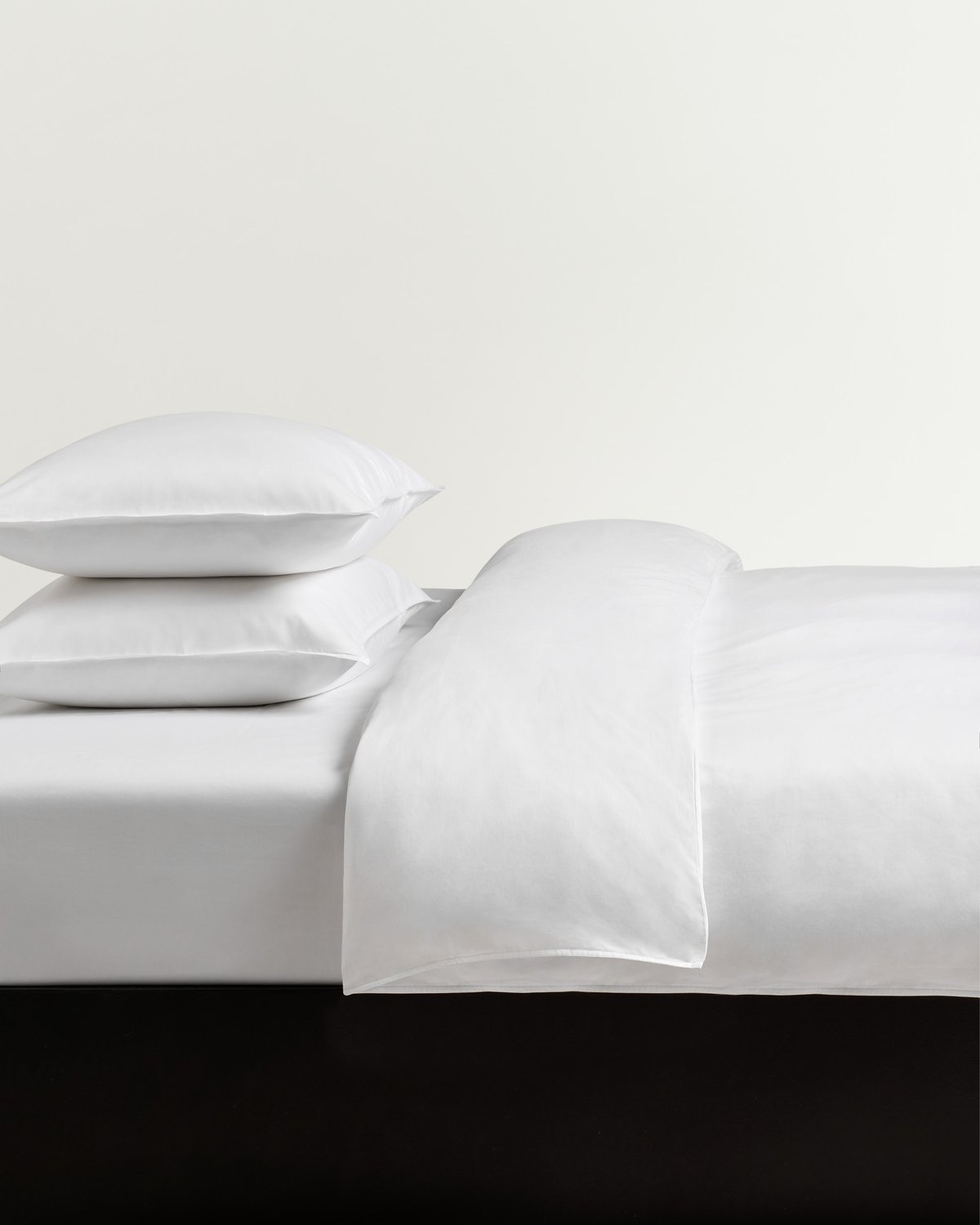 Sateen Duvet Cover Set in Crisp White styled on a bed, highlighting the smooth, luminous finish of cotton sateen.