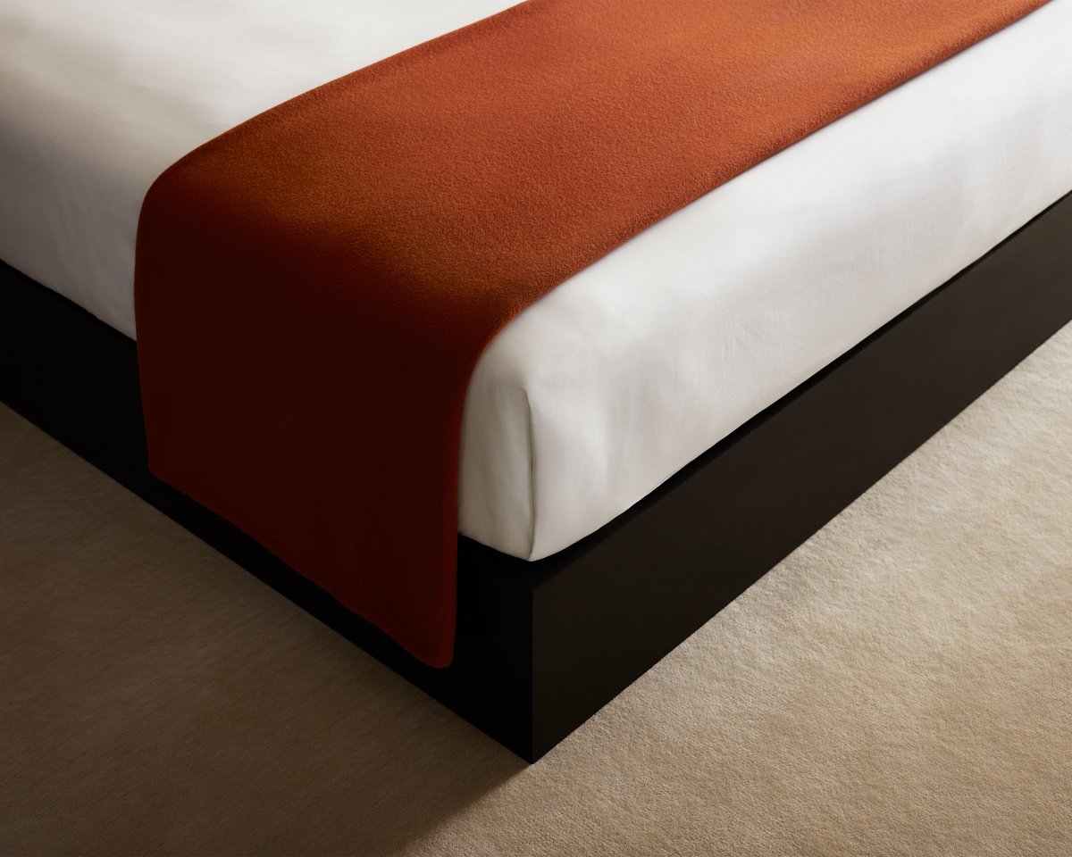 Bed styled in Crisp White bedding, finished with the Heritage Throw in Rust.