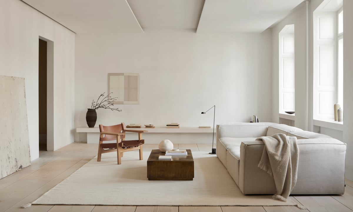Merino in Natural White, styled in a serene, light-filled living space with soft textures and warm wooden accents.