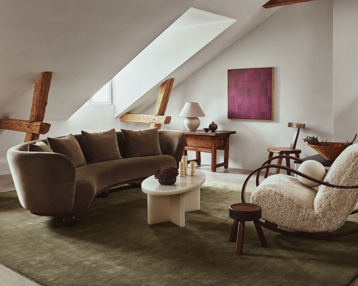 Grand Moss rug pictured in a living room with wooden beams in Stockholm.