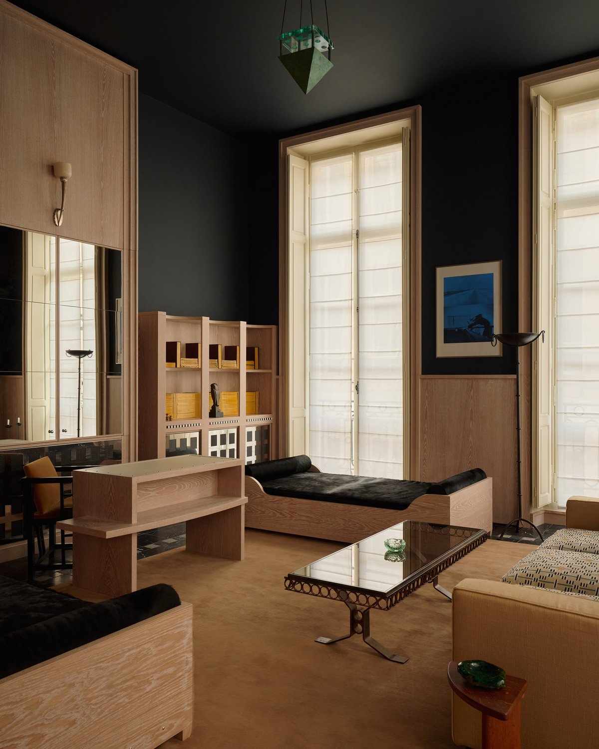 Grand in Leo, photographed in a living room beneath low seating and a glass coffee table in warm, natural light.