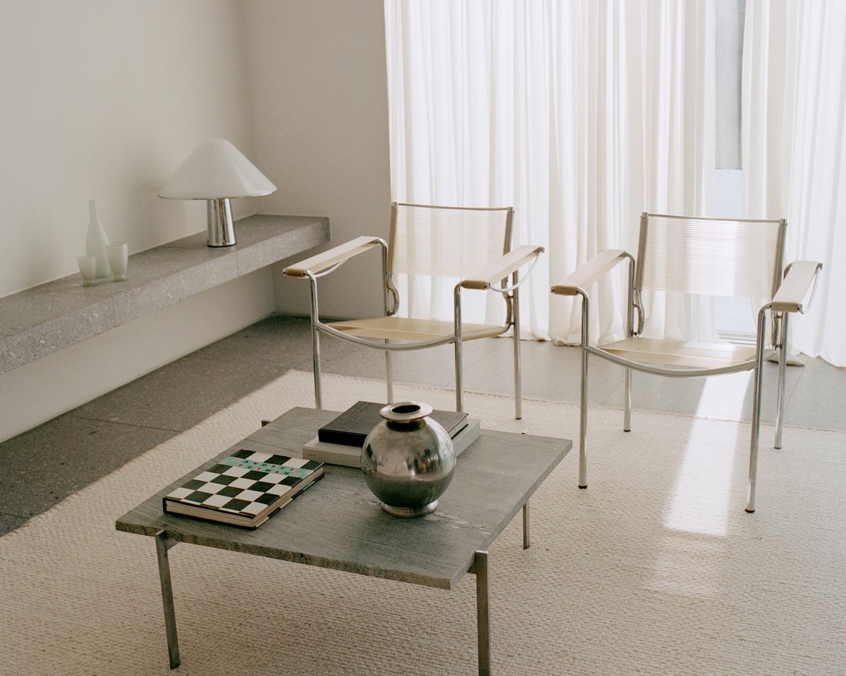 Wool flatweave rug Zero Basket Sand Mix photographed in a modern living room with light colored furniture and concrete interior details in Falsterbo, Sweden.