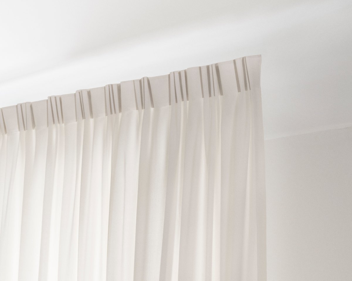 An image showing the installed The Grand wool curtains with the 4-finger hooks.