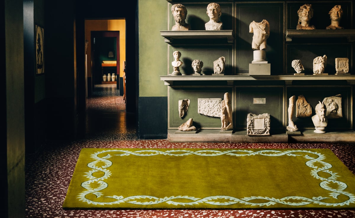 Climbing Vine – Olive weaves classic ornament into a bold, contemporary palette. Its soft green base and intricate border add richness and rhythm to a storied interior, echoing the sculptural forms and timeless atmosphere of the space.