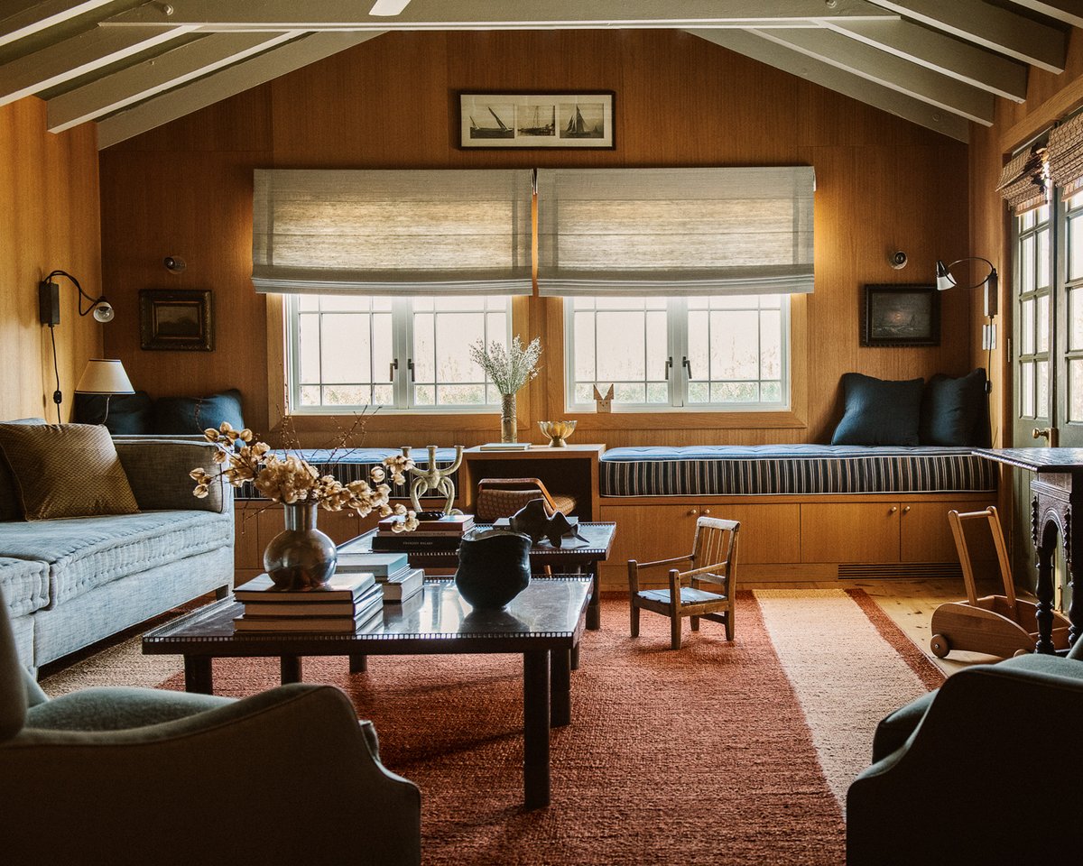 Jute stripes in Red designed by Michelle R. Smith pictured in a grand living room with great wooden details, capturing the warmth of the room and its beautifully rustic interior.