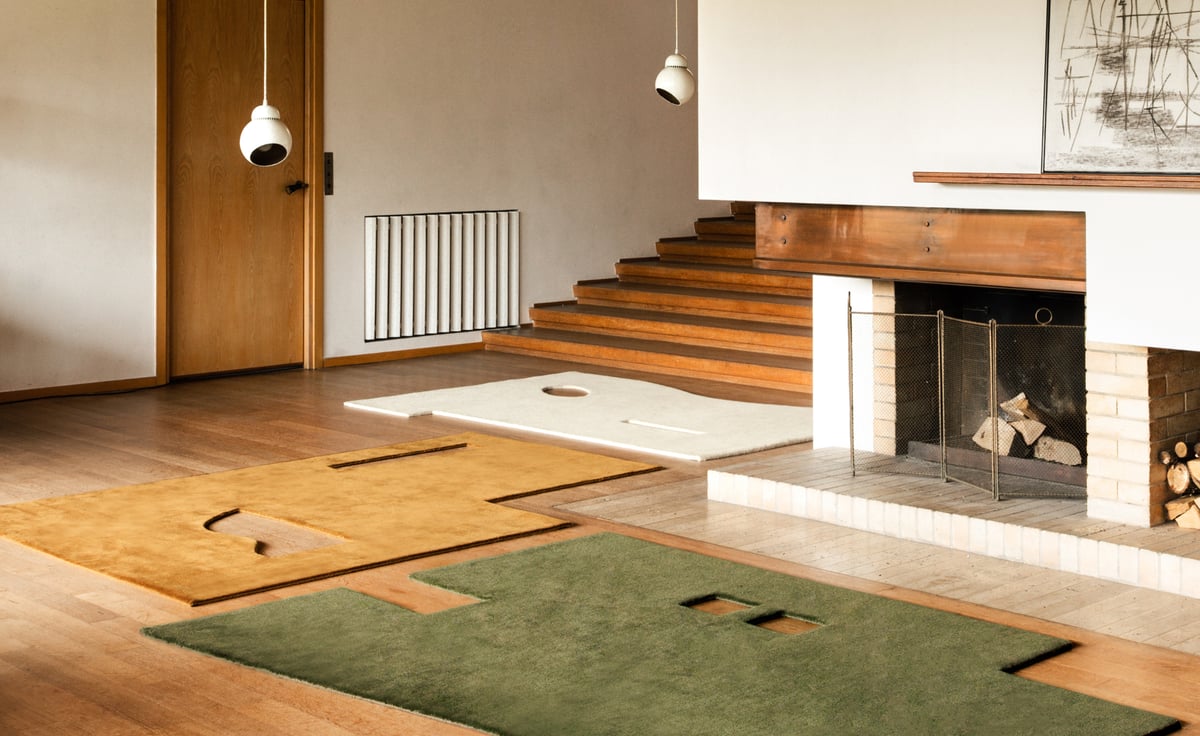 Garance in Moss, Leo, and Dusty White creates a sculptural landscape of color and form. The layered pile cut-outs echo the clean lines of the wood-panelled interior, while warm lighting and natural textures bring softness to the architectural composition.